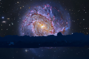 Wall Mural - blur nebula and galaxy back on night sky silhouette mountain and lake reflection