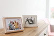 © New Africa - Family portraits in frames on cabinet indoors