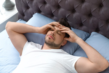 Poster - Sleepy man lying on pillow, view from above. Bedtime