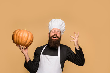 Harvest festival. Bearded man hold squash. Healthy product. Organic food. Male chef in uniform with pumpkin. Happy halloween. Thanksgiving day cooking or autumn recipes concept. Chef man with pumpkin.