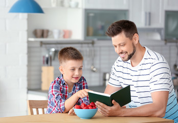 Sticker - Dad and son reading interesting book in kitchen