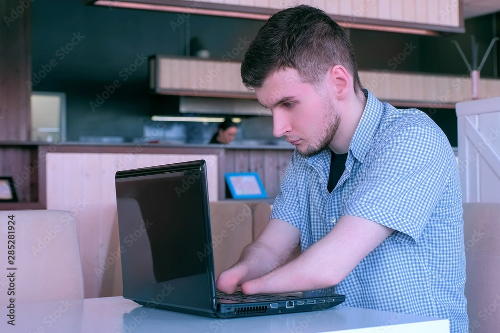 Computer online job. Disabled man freelancer with amputated two stump ...