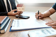 © Pichsakul - Real Estate broker or sale agent giving consultation to customer about buying house sign agreement document contract. Home loan.