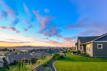 A Beautiful, Colorful Sunset Of Pinks And Aqua Blues Color The Sky Over A Typical American Subdivision On A Hillside In Spokane, Washington