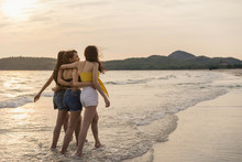 Group Of Three Asian Young Women Walking On Beach, Friends Happy Relax Having Fun Playing On Beach Near Sea When Sunset In Evening. Lifestyle Friends Travel Holiday Vacation On Beach Summer Concept.