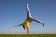 © Tim Booth Photography/Stocksy - A young red-headed doing a cartwheel.
