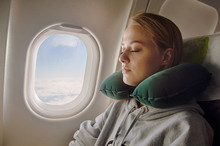 Young woman sleeping in plane