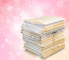 Stack of documents in folders isolated on white