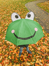 Kid With Umbrella In Fall