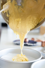 Wall Mural - Pouring Cake Batter Out of Mixing Bowl