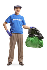 Wall Mural - Senior man volunteering and holding a plastic bag