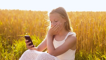 Wall Mural - technology, summer and people concept - smiling young girl in white dress with smartphone on cereal field