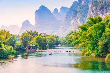 Wall Mural - Landscape of Guilin. Tourists are visiting by Bamboo raft. Located in Yangshuo, Guilin, Guangxi, China.