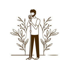 Canvas Print - silhouette of man with microphone and branches and leaves in the background