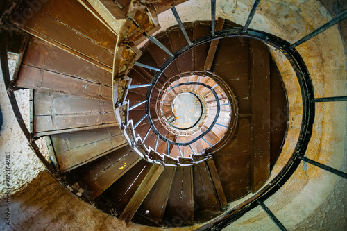 Cuadros en Lienzo Old spiral staircase in abandoned mansion, bottom view