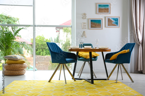 Cuadros en Lienzo Modern dining room interior with served table and chairs