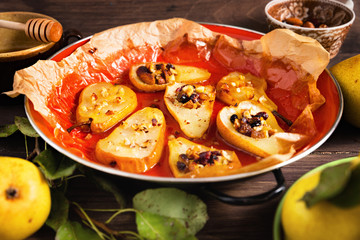 Close-up of baked pears with mixed nuts and honey.