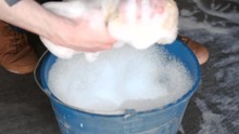 Washing A Car By Hand. Foam In A Bucket