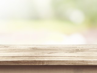 Poster - Brown desk in a white empty room lit by the sun