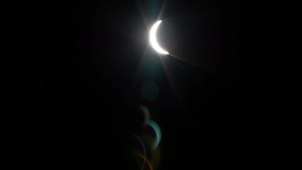 Wall Mural - solar eclipse timelapse. waxing crescent on black sky background