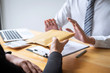 © Ngampol - Anti bribery and corruption concept, Business man refusing and don't receive money banknote in envelope offer from business people to accept agreement contract of investment deal