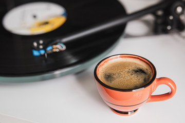 cup of coffee espresso on turntable vinyl music