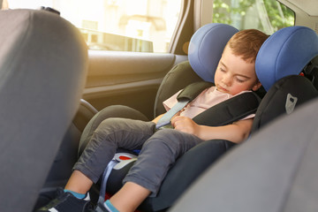 Canvas Print - Sleeping baby boy buckled in car seat