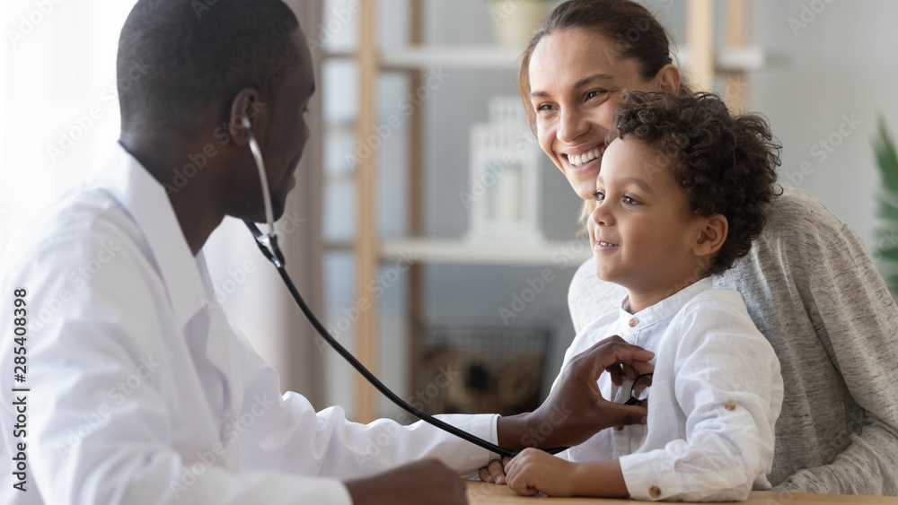 African male pediatrician hold stethoscope exam child boy patient - obrazy, fototapety, plakaty 