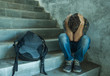 © TheVisualsYouNeed - Campaign vs homophobia with young sad and depressed college student man sitting on staircase desperate victim of harassment suffering bullying and abuse