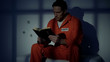© motortion - Imprisoned religious male reading bible, convicting in sins, feeling guilty