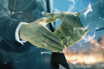 Double exposure of abstract technology drawing on cityscape background with two businessmen handshake. Concept of tech role in business