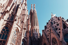 Sagrada Familia Building Exterior On Hot Summer Day In Barcelona Spain With Blue Sky