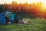 Fototapeta  - young couple relaxing by the river. camping outdoor