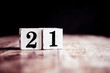 Number 21 isolated on dark background- 3D number twenty one isolated on vintage wooden table