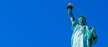 Panoramic Of The Statue Of Liberty In New York City. Statue Of Liberty With Blue Sky Over Hudson River On Island. Landmarks Of Lower Manhattan New York City.