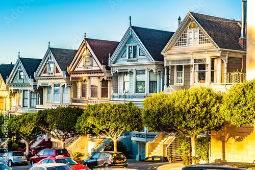 Row of charming colored Victorian style homes on the incline of ...