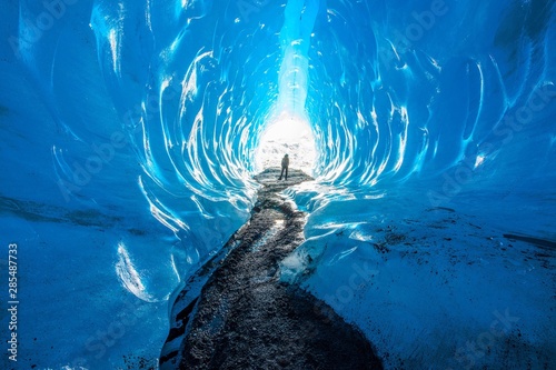 Cuadros en Lienzo A woman silhouette outside an ice cave in Alaska
