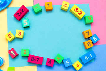Wall Mural - child kid colorful education toys cubes with numbers math pattern background on the bright background. Flat lay. Childhood infancy children babies concept.