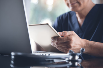 Wall Mural - Doctor working on laptop computer