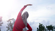 © SVRSLYIMAGES - back view of hijab woman doing stretching and warming up her body before running