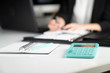 © zolnierek - Young businesswoman sitting on her workplace and looking at laptop in the office.