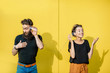 © rh2010 - Man and woman talking with string phone made of cups on the yellow background. Concept of broken phone and bad communication