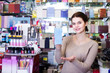 © JackF - female seller demonstrating perfume bottles in cosmetics shop