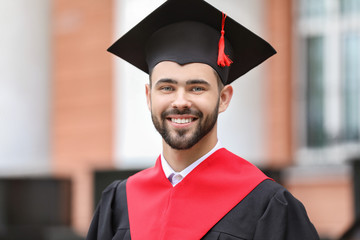 Sticker - Young student in bachelor robe outdoors