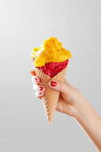 Woman Hand Holding Ice Cream Cone On A Neutral Background. Copy Space