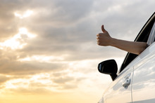 Man Showing Thumbs Up/making Like / Ok Sign With Hand From Car Window With Sunset Sky, Relaxing, Enjoying Road Trip And Feeling The Air And Freedom. Toward Adventure, Vacation 