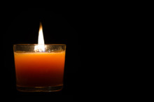 Candle With Fire On Dark Background.