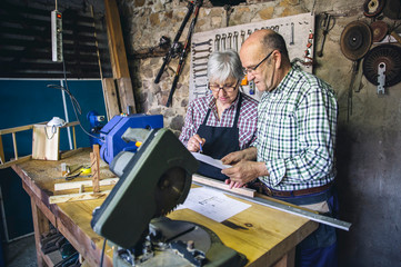 Wall Mural - Senior couple working in a carpentry workshop