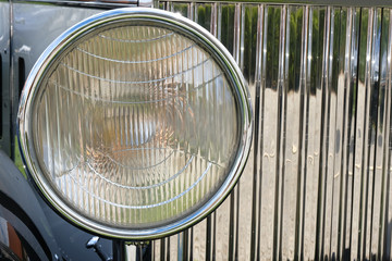 Headlight , radiator and hood of luxury retro  car ckose-up.