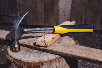 Hammer and nails on wooden plates